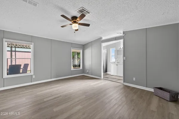 a view of a livingroom with a ceiling fan and window