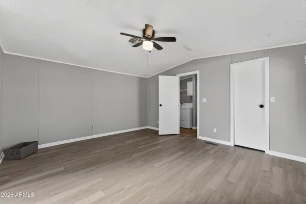 a view of an empty room with wooden floor