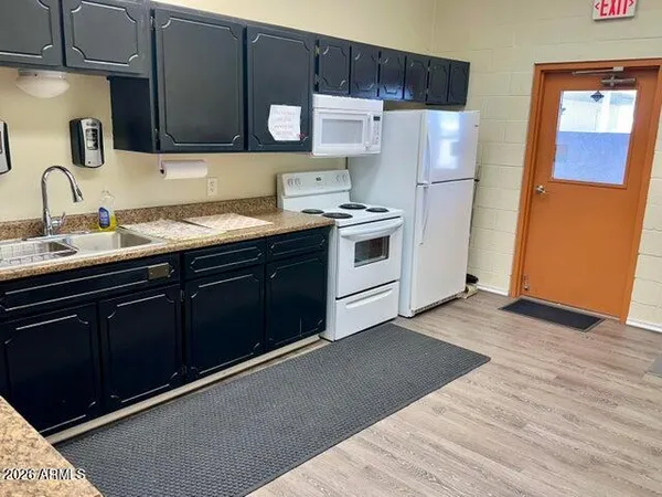 a kitchen with a sink and wooden cabinets