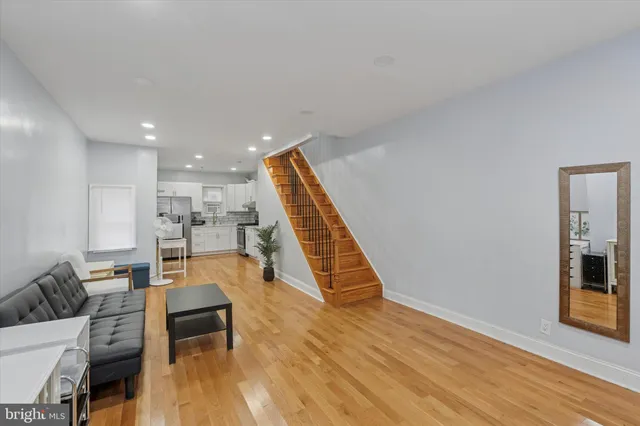 a living room with furniture and wooden floor