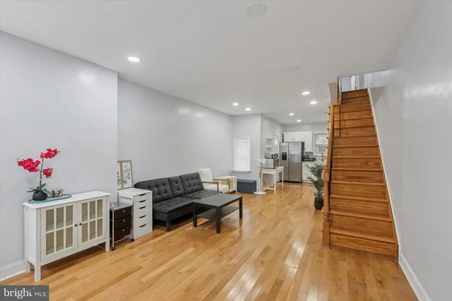 a living room with furniture and wooden floor