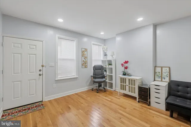 a livingroom with furniture wooden floor and windows