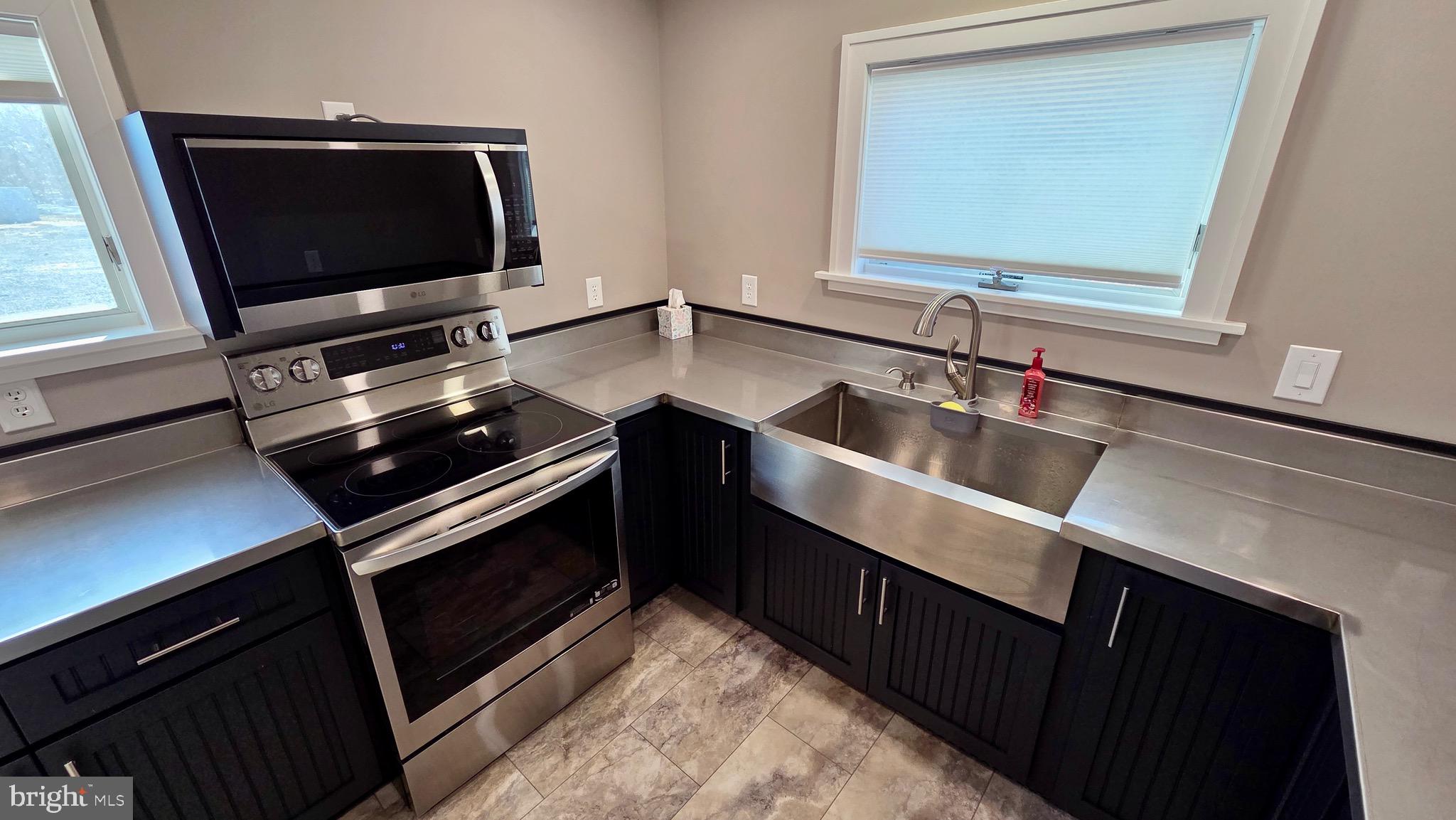 1074 Highway 103 Mount Union, PA 17066 - Photo 22 of 69 a kitchen with a sink stove and microwave