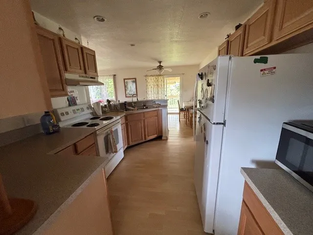a kitchen with a refrigerator a stove top oven a sink and dishwasher
