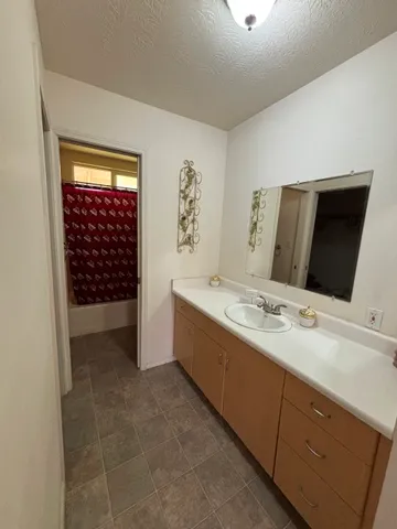 a bathroom with a double vanity sink and mirror