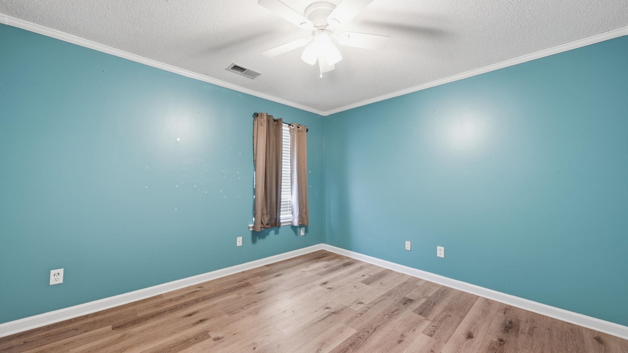 217 Rae Drive Munford, TN 38058 - Photo 24 of 40 Room featuring wood-finish flooring, a ceiling fan, and crown molding