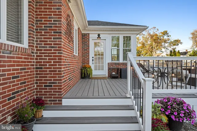 a view of balcony with wooden floor and seating space