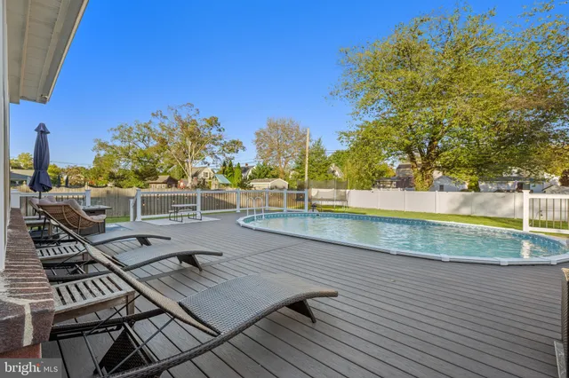 a view of a balcony with wooden floor and trees