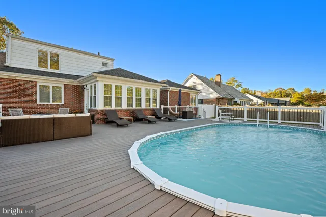 a view of a house with pool plants and wooden floor