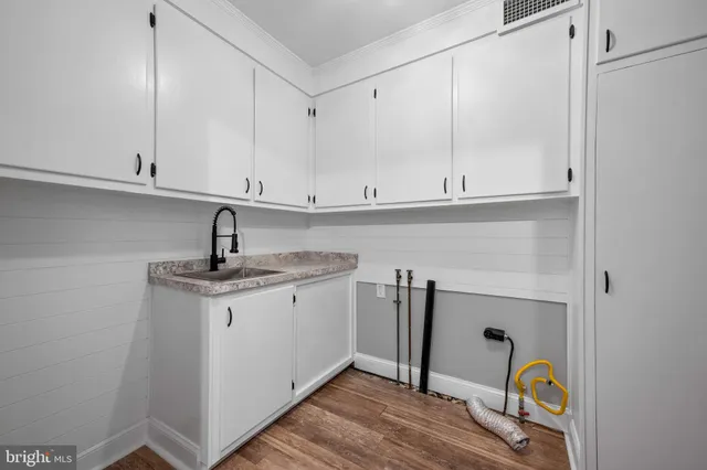 a kitchen with a sink and cabinets