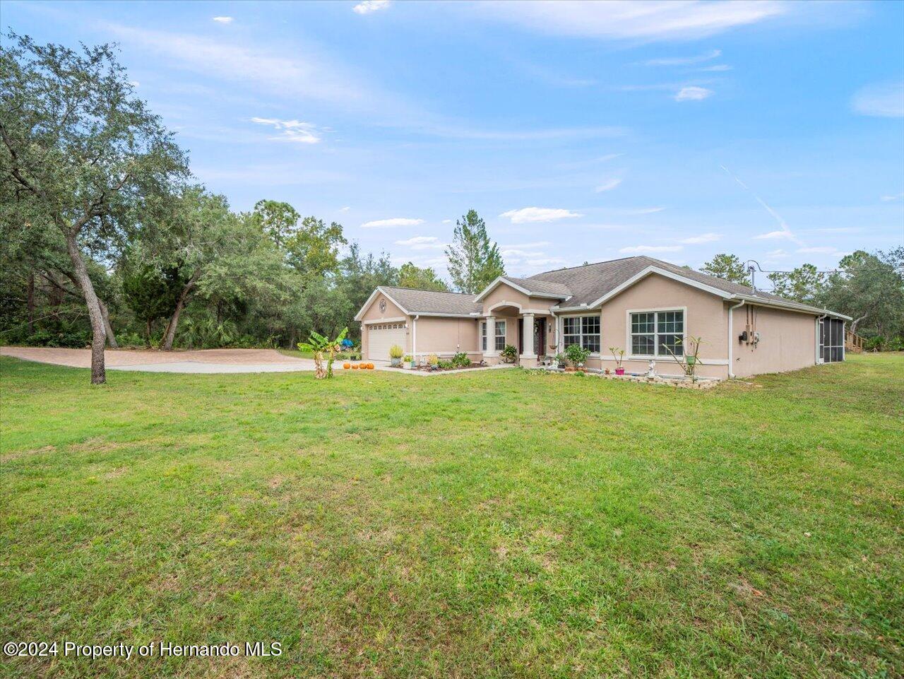8108 Indian Trail Road Weeki Wachee, FL 34613 - Photo 12 of 59 a view of a house with a yard