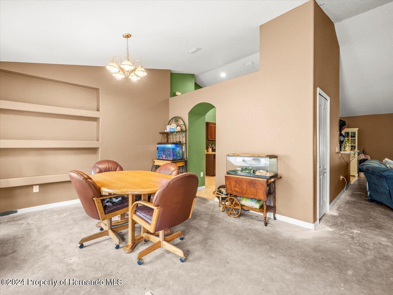 8108 Indian Trail Road Weeki Wachee, FL 34613 - Photo 14 of 59 a view of a room with furniture and a chandelier