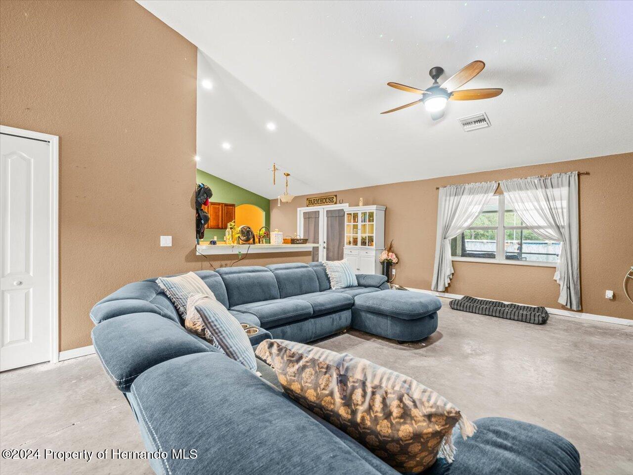 8108 Indian Trail Road Weeki Wachee, FL 34613 - Photo 18 of 59 a living room with furniture and a large window