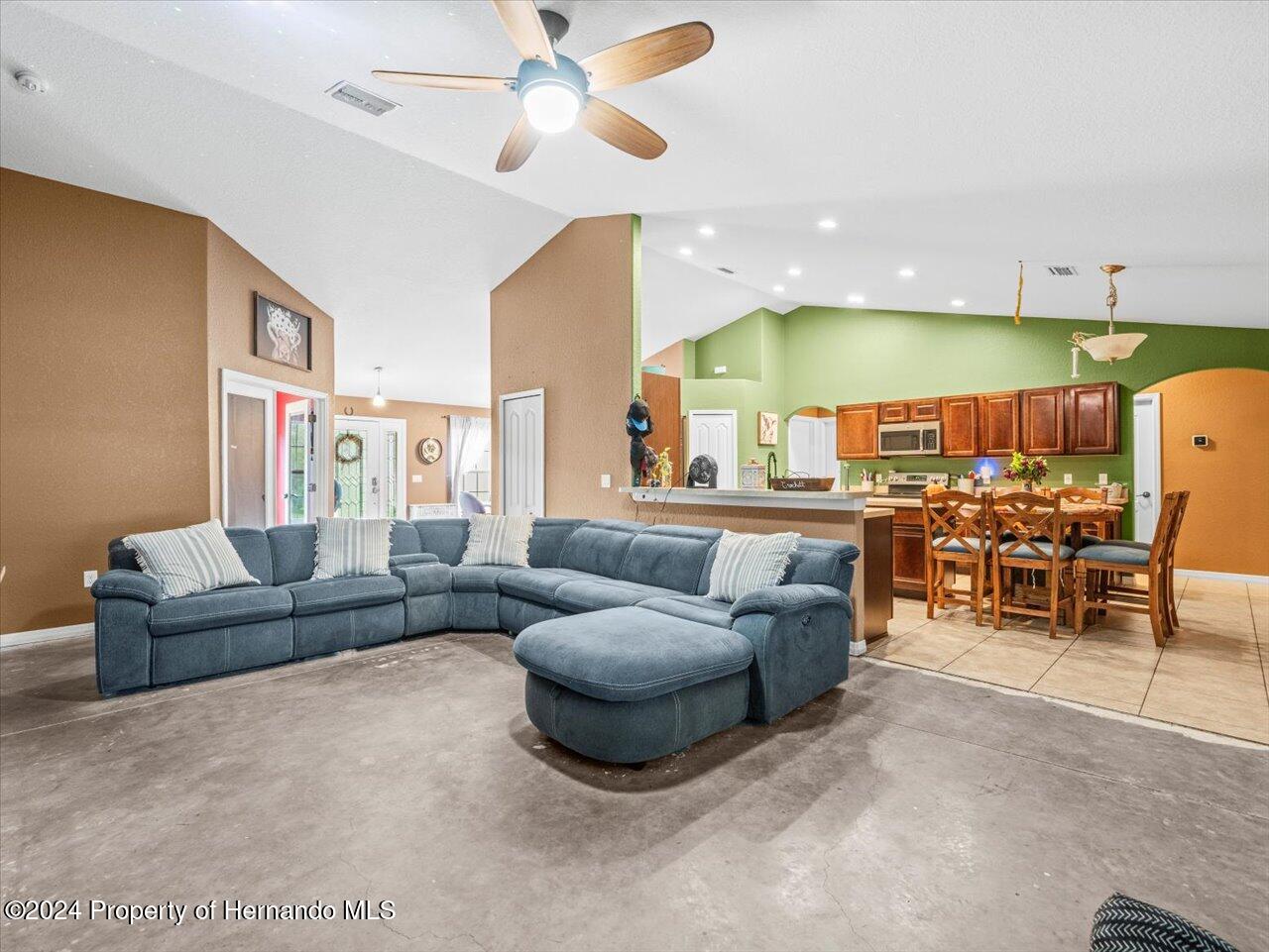8108 Indian Trail Road Weeki Wachee, FL 34613 - Photo 20 of 59 a living room with furniture and a large window