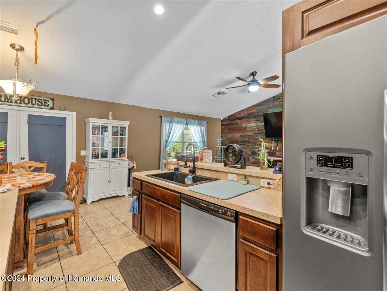 8108 Indian Trail Road Weeki Wachee, FL 34613 - Photo 29 of 59 a kitchen with stainless steel appliances granite countertop a sink and stove