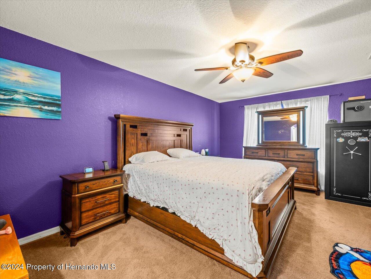 8108 Indian Trail Road Weeki Wachee, FL 34613 - Photo 31 of 59 a bedroom with a bed and a chandelier