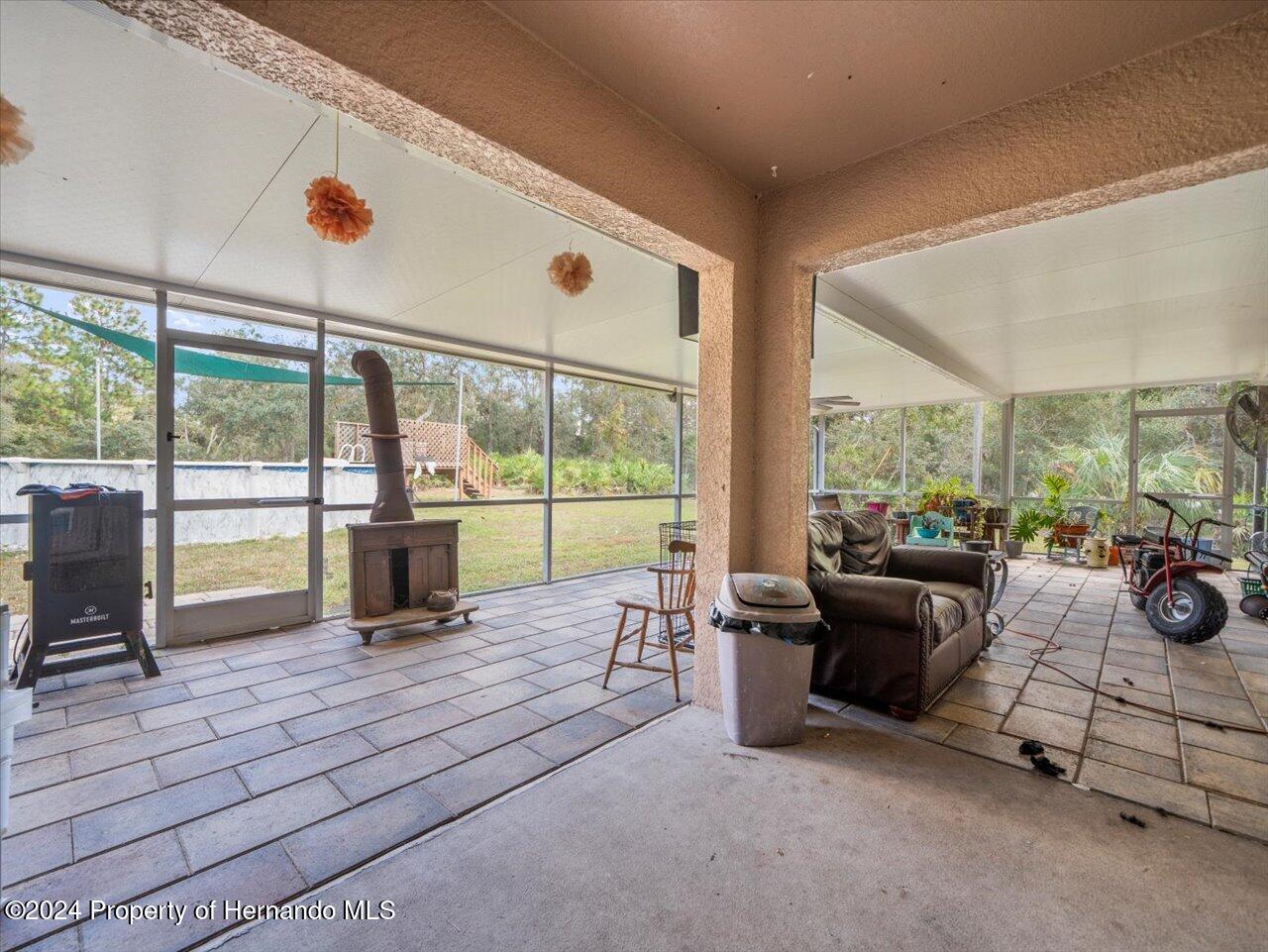 8108 Indian Trail Road Weeki Wachee, FL 34613 - Photo 48 of 59 a living room filled with furniture and floor to ceiling window