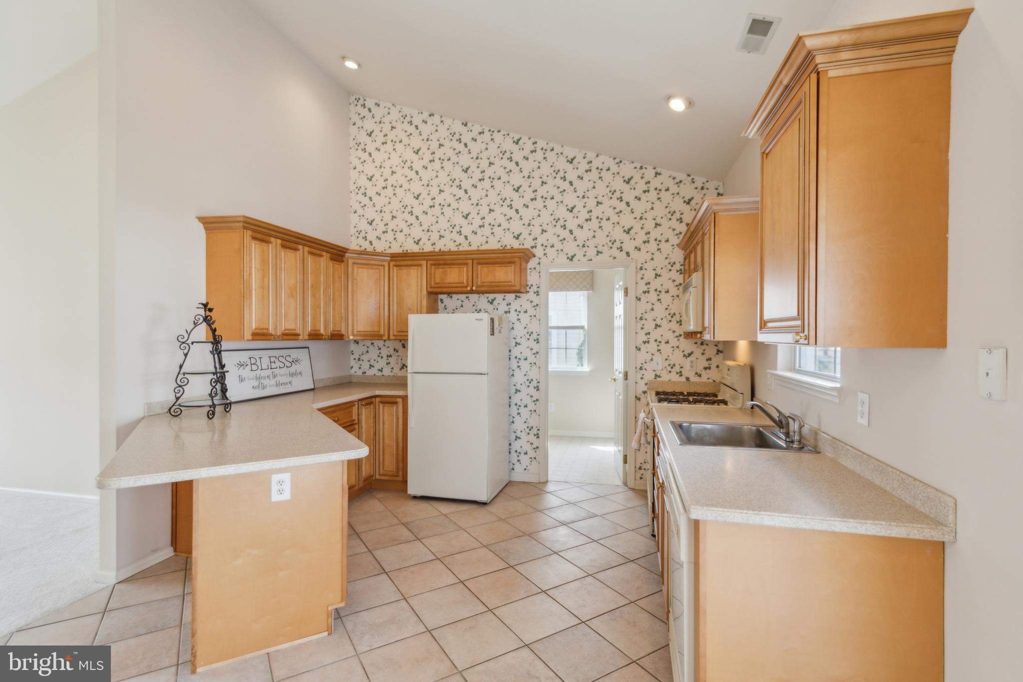 104 Trellis Lane Sewell, NJ 08080 - Photo 12 of 28 a kitchen with a sink a refrigerator and cabinets