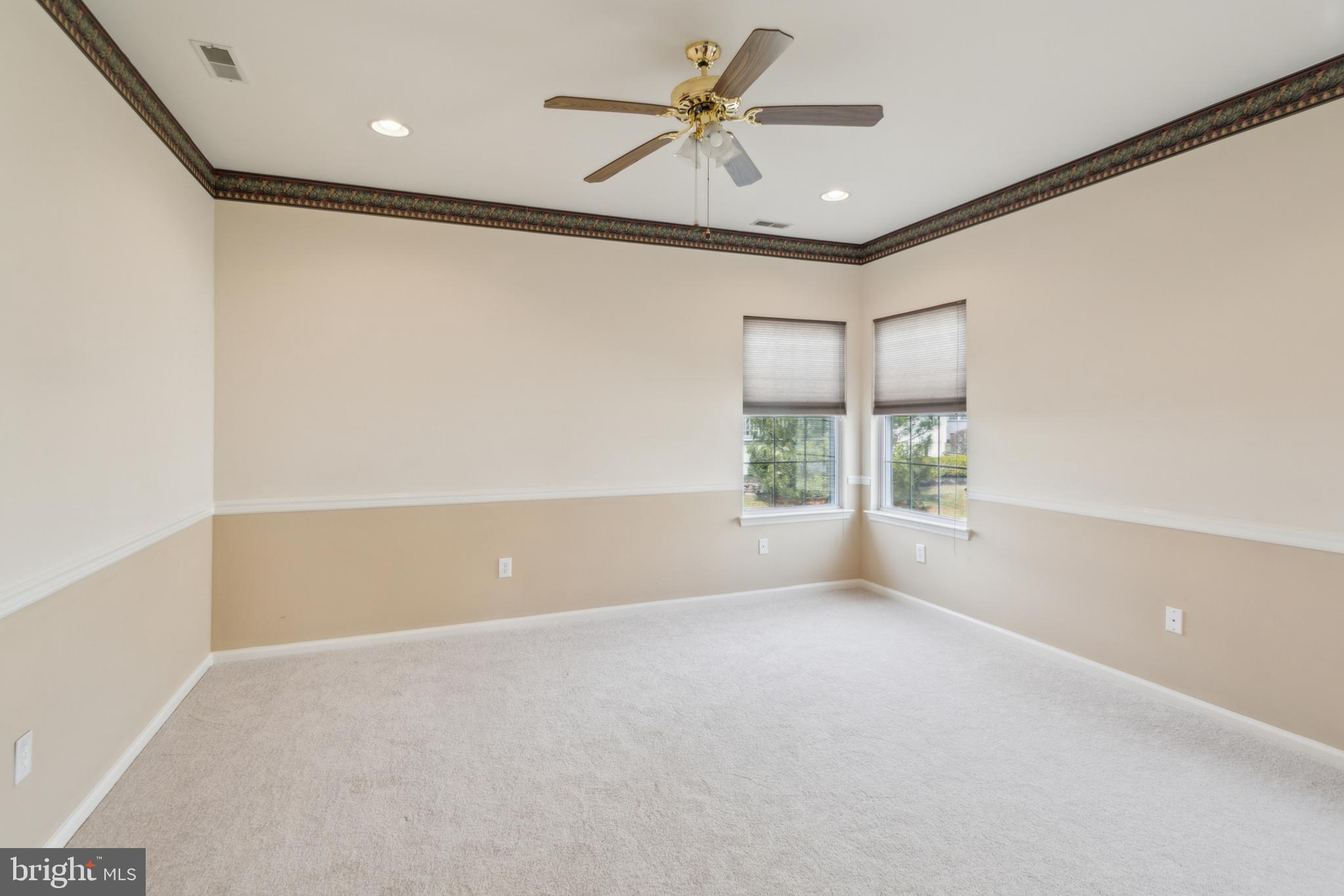 104 Trellis Lane Sewell, NJ 08080 - Photo 22 of 28 en empty room with windows and ceiling fan