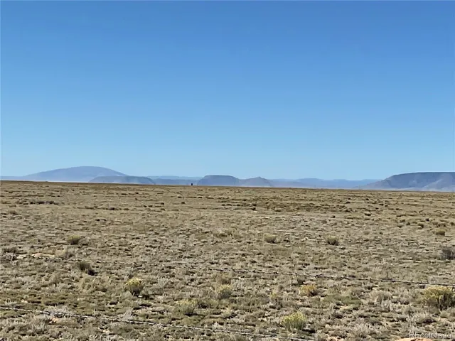a view of an ocean beach and mountain