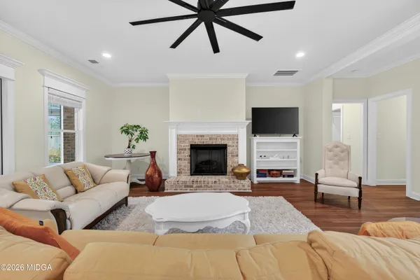 a living room with furniture and a fireplace