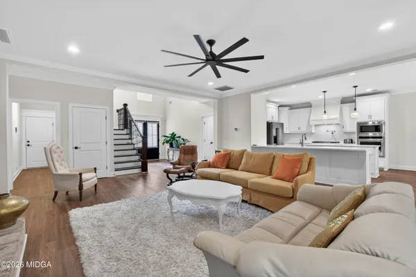 a kitchen with kitchen island granite countertop stainless steel appliances a stove sink microwave and cabinets