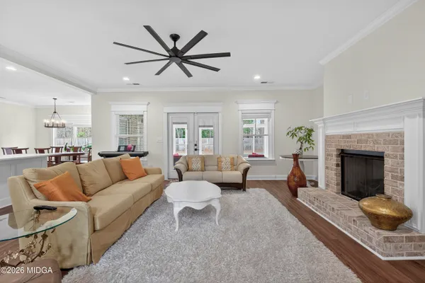 a kitchen with stainless steel appliances kitchen island granite countertop a stove a sink and a refrigerator