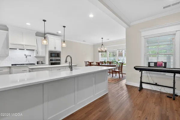 a large kitchen with kitchen island a white cabinets and outdoor view