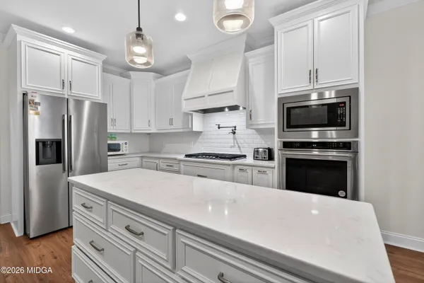 a view of a workspace with furniture and a ceiling fan