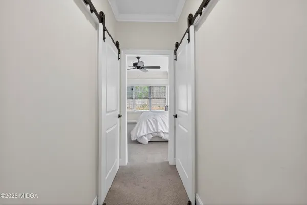 an empty room with windows and ceiling fan view