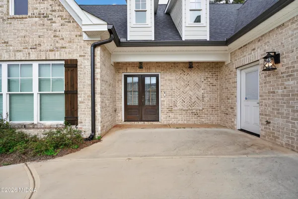 front view of a brick house with a yard