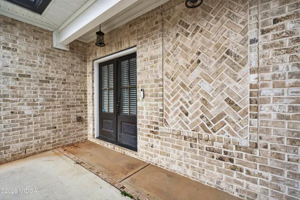 a brick building with a door and a window