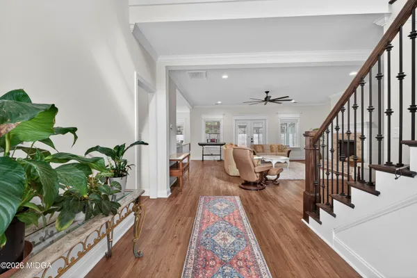a view of staircase with wooden floor and a potted plant