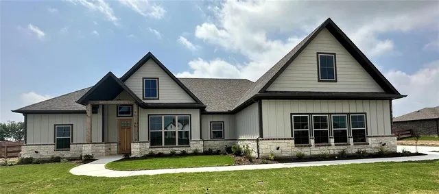 a front view of a house with a yard and porch