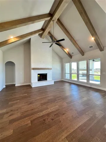 a view of a livingroom with a fireplace and window