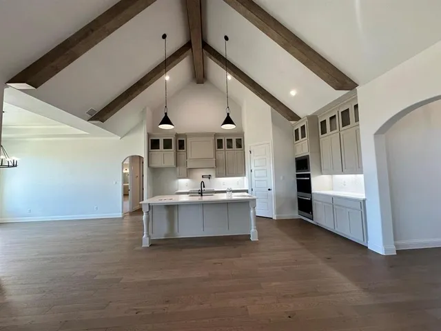 a view of a kitchen with cabinets and wooden floor