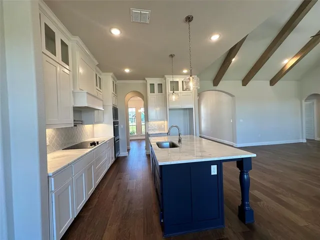 a large kitchen with a large counter top appliances