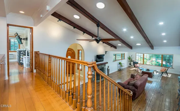 a bedroom with a bed couch and a large window
