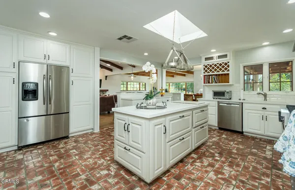 a bathroom with a granite countertop sink a large mirror and a shower