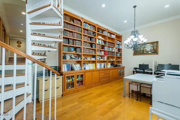 a spacious bedroom with a bed and a flat screen tv