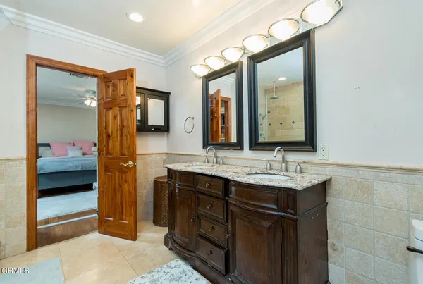 a en suite bathroom with a sink and a mirror