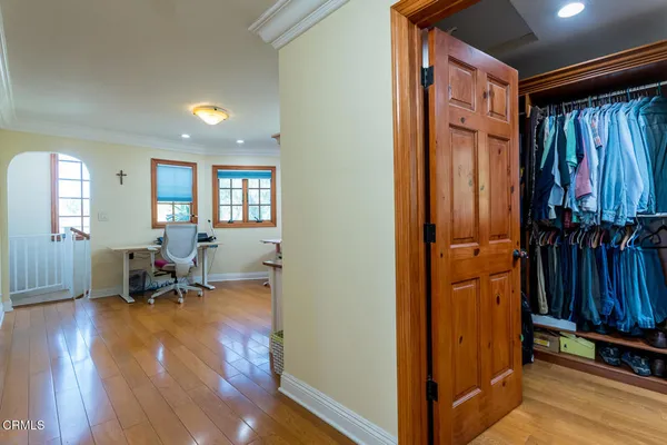 a view of walk in closet with clothes and shoes