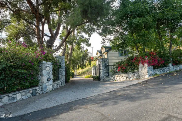 a view of a house with a yard and tree s