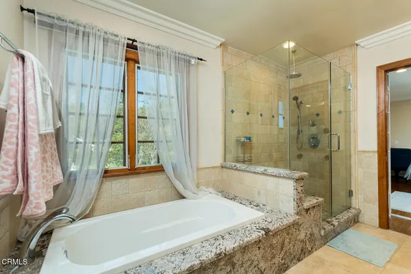 a front view of a house with a yard and potted plants