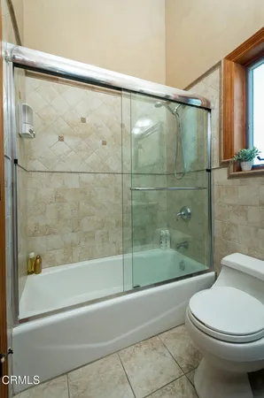 a view of a yard with plants and a fountain