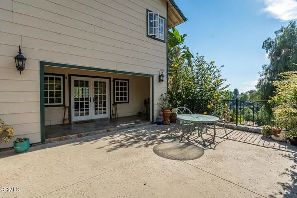 a kitchen with a refrigerator and white cabinets