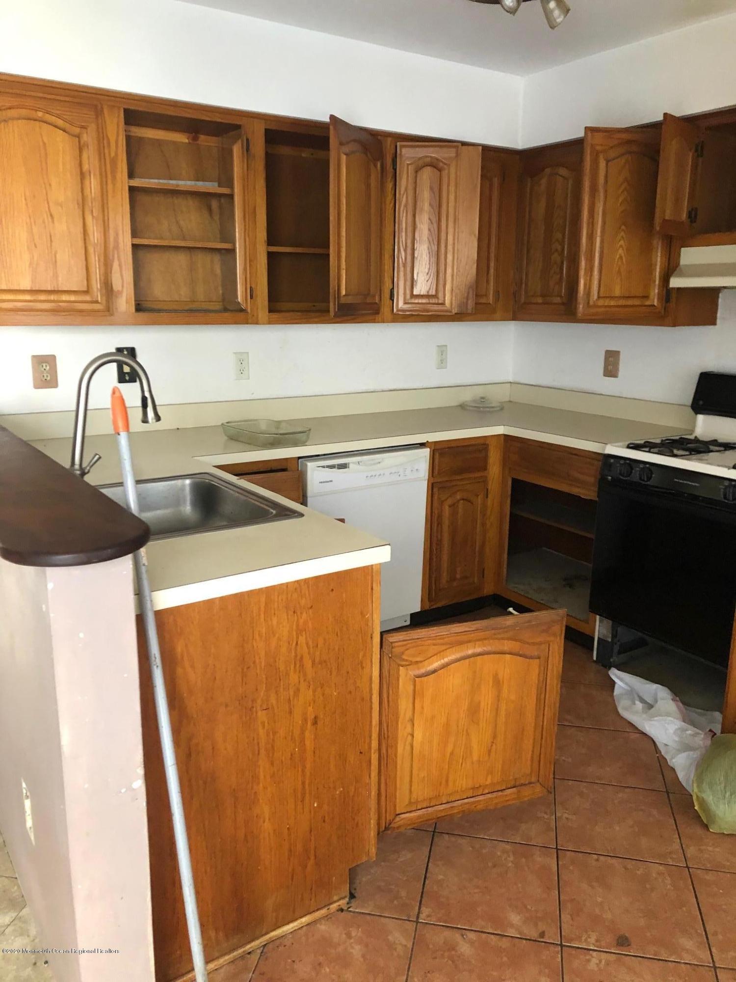 276 Sugar Maple Court Howell, NJ 07731 - Photo 14 of 16 a kitchen with a sink a stove and a microwave