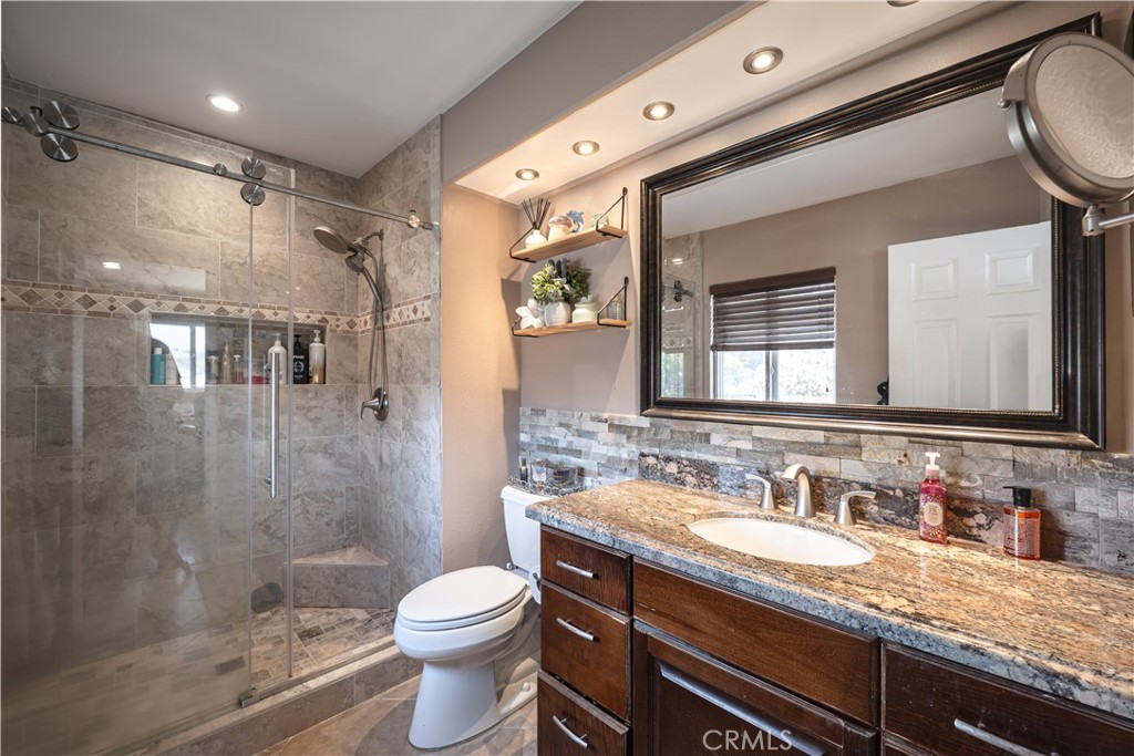 2203 Homewood Avenue Simi Valley, CA 93063 - Photo 31 of 37 a bathroom with a granite countertop sink toilet and shower