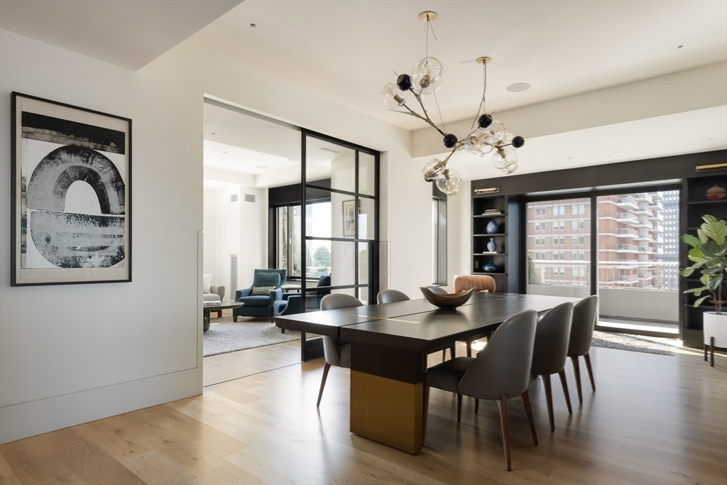 1 Huntington Avenue, Unit 1702 Boston, MA 02116 - Photo 12 of 42 a view of a dining room with furniture window and wooden floor