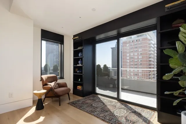 a living room with furniture and a floor to ceiling window